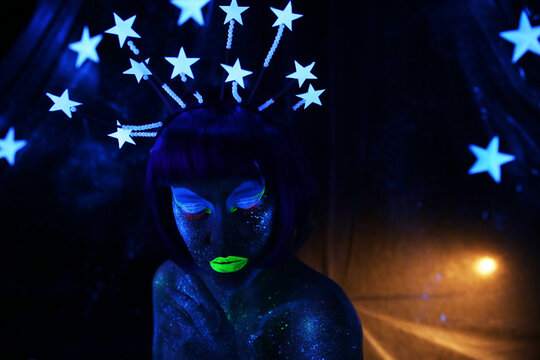 Neon visage. Beautiful girl in the image of the month with stars