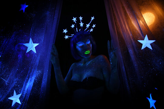 Neon visage. Beautiful girl in the image of the month with stars