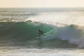 Surfer on Blue Ocean Wave . Surf spot in Ericeira Portugal.