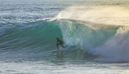 Surfer on Blue Ocean Wave . Surf spot in Ericeira Portugal.