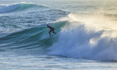 Surfer on Blue Ocean Wave . Surf spot in Ericeira Portugal.