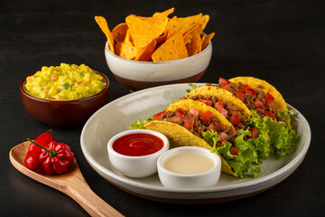 Mexican tacos with lettuce, beef and tomatoes.