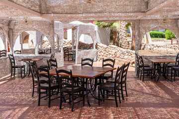 Wooden table and chairs in beach cafe next to the red sea in Sharm el Sheikh, Egypt
