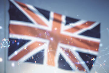 Abstract virtual wireless technology hologram on British flag and blue sky background. Big data and database concept. Multiexposure