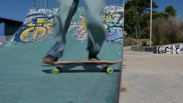 Skate park in Lisbon, skater using the half pipe 