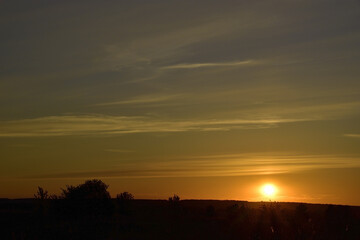 Summer sunset on the background of light cirrus clouds