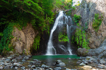 It's autumn time. Beautiful waterfall streams and colorful leaves.	