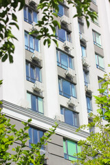 Fototapeta na wymiar Exterior of a modern residential building. Windows, air conditioning on a facade