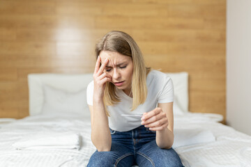 Sad one woman complains about pregnancy test sitting on sofa in living room at home, frustrated...
