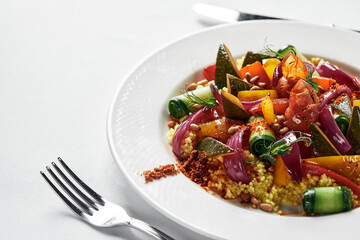 Vegetable stew with zucchini, tomatoes and bell pepper in a creamy sauce in a plate, on a white plate cooking vegetable stew.