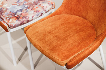 Orange contemporary armchairs with velour upholstery and white metal legs