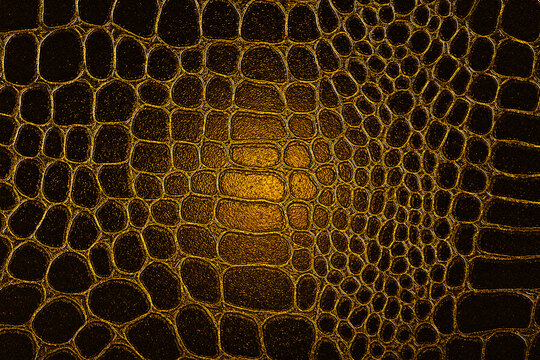Dark crocodile skin texture in yellow color. Reptile leather imitation texture to background