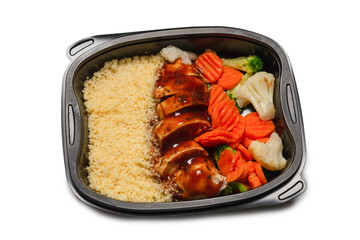 Ready food in a container. Stewed chicken in teriyaki sauce, stewed carrot, cabbage and porridge.