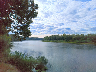 Landscape with river in summer. River landscape with white clouds