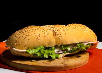Natural Sandwich on a wooden plate on a dark background. Selective Focus.	