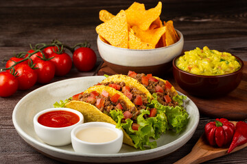 Mexican tacos with lettuce, beef and tomatoes.