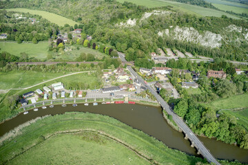 Aerial view towards Amberley with boats on the River Arun ang the road over the bridge.