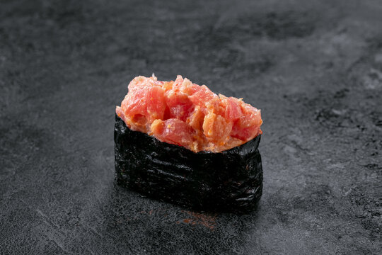 Gunkan sushi with spicy salmon on stone