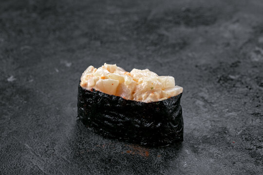 Gunkan sushi with spicy Scallop on stone