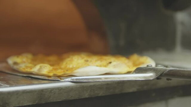 Baking Manakish. Lebanese Food:   A cook preparing zaatar pizza 