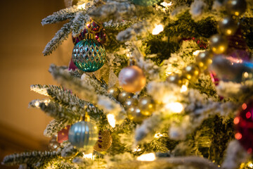 Christmas tree ornaments with gold and green bulbs. Close up