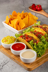 Mexican tacos with lettuce, beef and tomatoes.