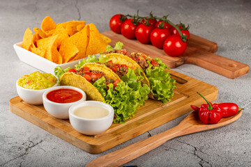 Mexican tacos with lettuce, beef and tomatoes.