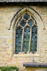 Fototapeta na wymiar Old crooked church window