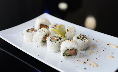 Sushi rolls on white dish. Japanese food.