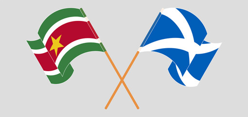 Crossed and waving flags of Suriname and Scotland