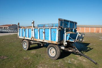 Blue wagon for the transport of grain and straw used intensively in a farm