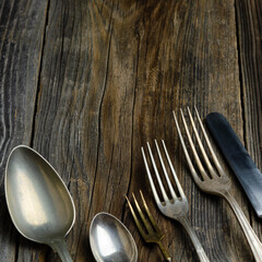 Old cutlery on a wooden background, copy space available 