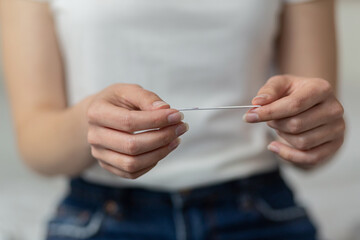 Closeup woman hand holding  pregnancy test. health care concept, selective focus
