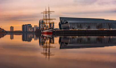 Fototapeta na wymiar Glasgow Scotland 02 March 2021 reflection of ship at sunset over the river clyde, Glasgow March 2021