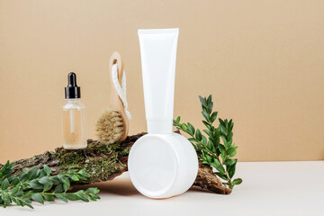 Natural skin care for the face. Eco-friendly cosmetics. A jar, a tube, a facial brush are on the bark of a tree. Copy space