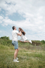 Dad throws his daughter into the sky. Happy family concept. Dad and daughter have fun in the field . 