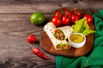 Mexican burritos stuffed with beef and salad.