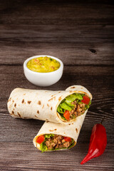 Mexican burritos stuffed with beef and salad.