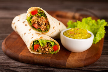 Mexican burritos stuffed with beef and salad.