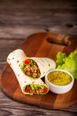 Mexican burritos stuffed with beef and salad.