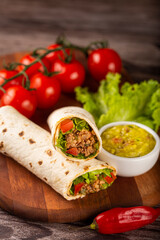 Mexican burritos stuffed with beef and salad.