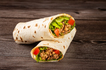 Mexican burritos stuffed with beef and salad.
