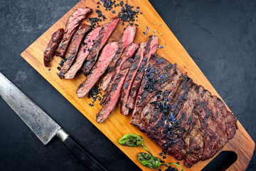 Modern style traditional barbecue wagyu bavette steak with green chili and spices served as top...