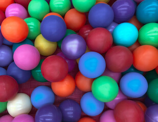 Bright multi-colored balls for the pool for childrens games.Toys for children,entertainment for kids.Use in catalogs of childrens stores,advertising entertainment centers.Bright multi-color background