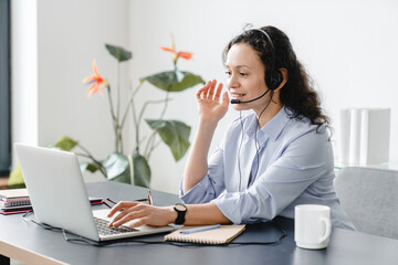 Confident caucasian IT support call center female worker in headset watching conducting webinars...