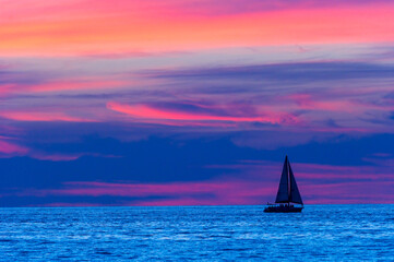 Fototapeta na wymiar Sailboat Sunset Night Sailing Surreal Colors