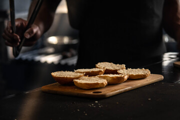 Chef with open hamburger buns