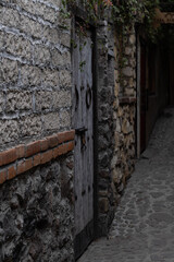 Alley with rock walls and a grey door