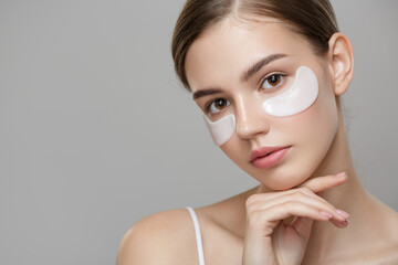 Eye Skin Beauty. Closeup Of Beautiful Young Woman Face With Natural Makeup, Healthy Fresh Skin And Collagen Hydrogel Eye Patches.