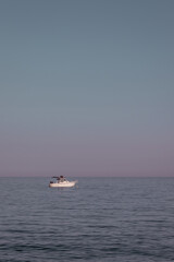 A small boat on a super calm sea 